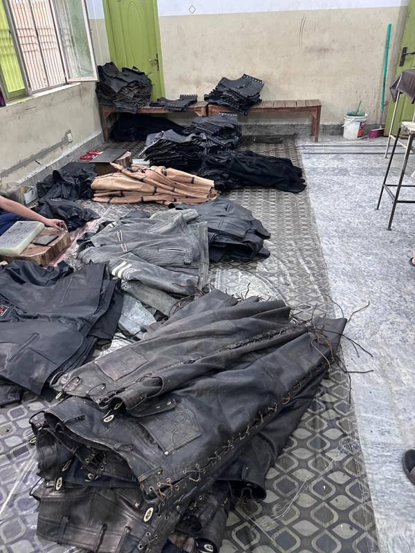 Cut and sorted leather jackets and vests staged for stitching
